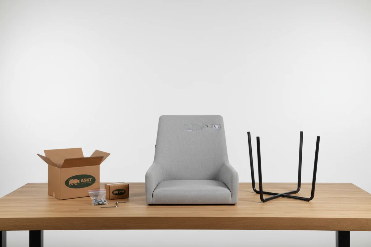 An disassembled flat-pack upholstered dining chair with its components organized neatly